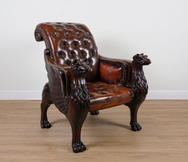 A LARGE STUDDED TAN LEATHER UPHOLSTERED DESK CHAIR ON GRIFFIN SUPPORTS