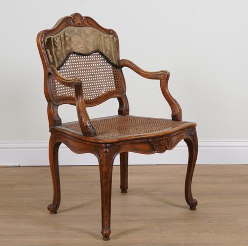 A LOUIS XVI STYLE WALNUT FRAMED OPEN ARM BERGERE CHAIR
