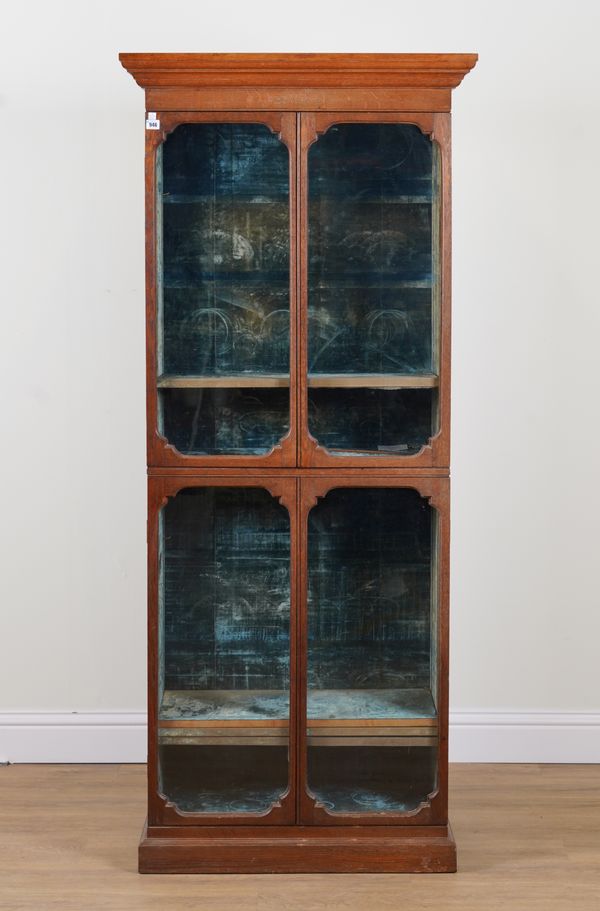 A VICTORIAN OAK GOTHIC REVIVAL FLOORSTANDING DOUBLE HEIGHT DISPLAY CABINET