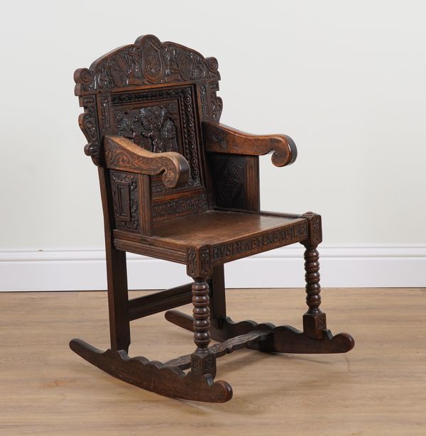 A CARVED OAK ROCKING ARMCHAIR INCORPORATING 17TH CENTURY ELEMENTS