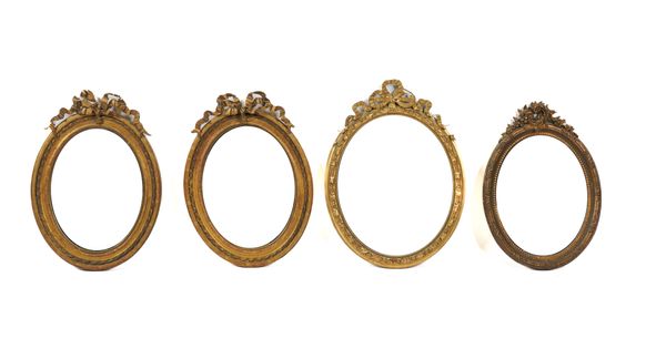 A PAIR OF FRENCH GILT FRAMED RIBBON CREST OVAL WALL MIRRORS (4)