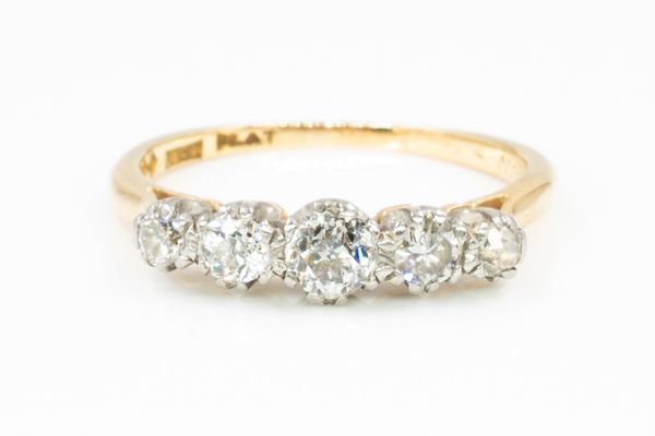 A GOLD AND DIAMOND FIVE STONE RING