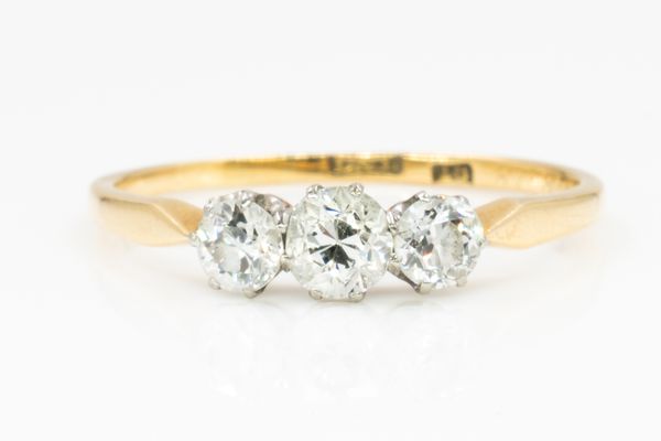 A GOLD AND DIAMOND THREE STONE RING