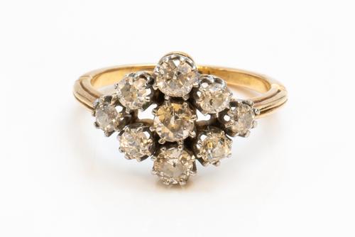 A GOLD AND DIAMOND NINE STONE CLUSTER RING