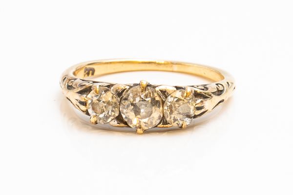 A GOLD AND DIAMOND THREE STONE RING