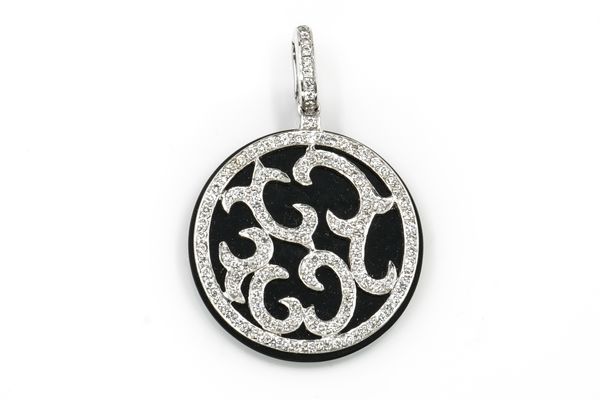 A WHITE GOLD, DIAMOND AND BLACK ONYX CIRCULAR PENDANT