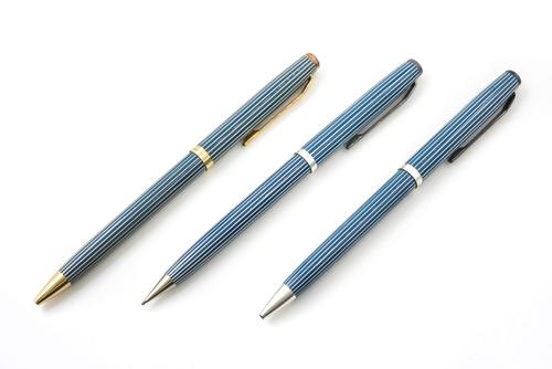 AN 18CT GOLD CASED BALLPOINT PEN AND TWO FURTHER WRITING IMPLEMENTS (3)
