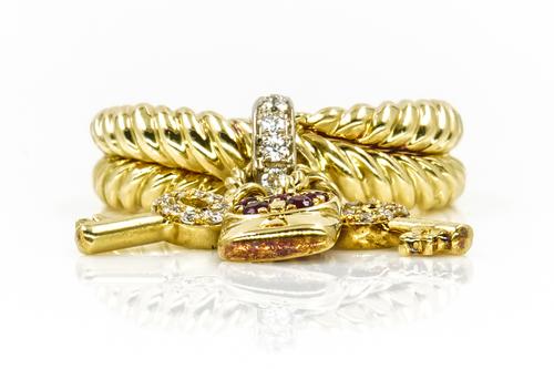 A YELLOW GOLD, RUBY AND DIAMOND KEYS AND LOCK RING