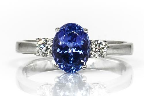 A WHITE GOLD, TANZANITE AND DIAMOND THREE STONE RING