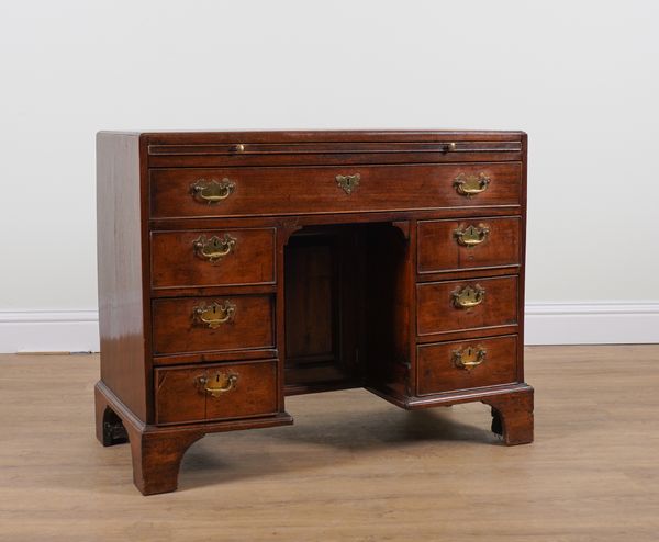 A GEORGE III MAHOGANY SEVEN DRAWER KNEEHOLE DESK