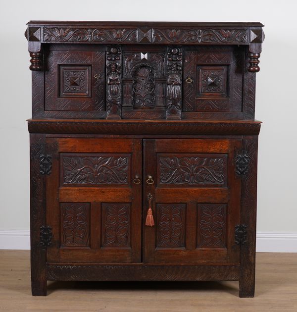 A 17TH CENTURY AND LATER CARVED OAK COURT CUPBOARD