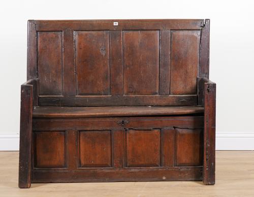 AN 18TH CENTURY AND LATER CARVED OAK SETTLE