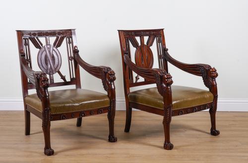 A PAIR OF LARGE CARVED HARDWOOD FRAMED OPEN ARMCHAIRS (2)