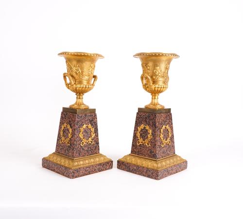 A PAIR OF GILT-METAL MOUNTED CAMPANA URNS ON POLISHED GRANITE PLINTHS (2)
