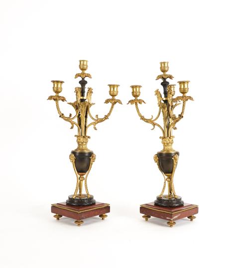 A PAIR OF LOUIS XVI STYLE GILT AND PATINATED METAL MOUNTED FOUR LIGHT CANDELABRA (2)