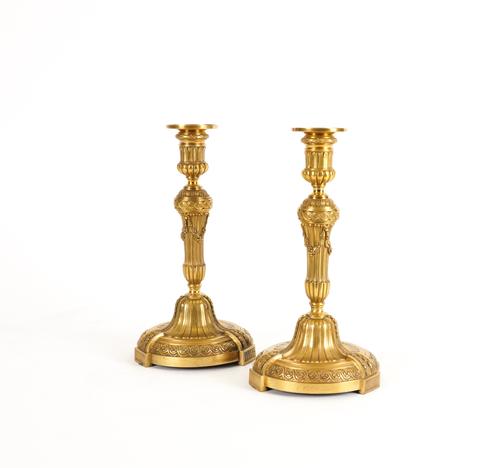 A PAIR OF FRENCH LOUIS XVI STYLE GILT-BRONZE CANDLESTICKS (2)