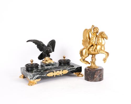A GILT-BRONZE MODEL OF A CUPID RIDING PEGASUS AND A BRONZE AND VERDE ANTICO DESK STAND (2)
