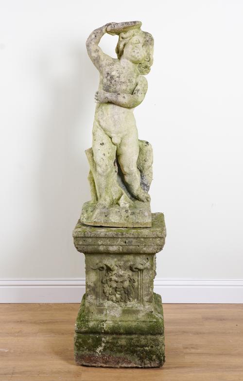 A CARVED STONE FIGURE OF A PUTTO ON COMPOSITE STONE PEDESTAL BASE
