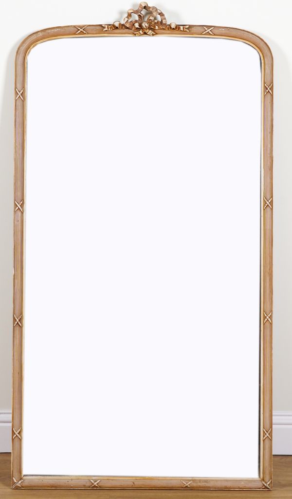 A CREAM PAINTED ARCH TOP OVERMANTEL MIRROR WITH RIBBON TIED REEDED FRAME