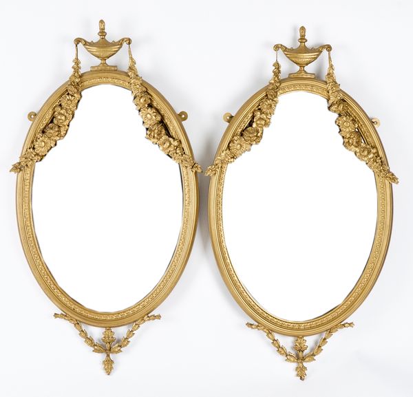 A PAIR OF LOUIS XVI STYLE GILT FRAMED OVAL WALL MIRRORS (2)