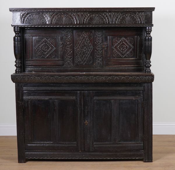 A 17TH CENTURY AND LATER CARVED OAK COURT CUPBOARD