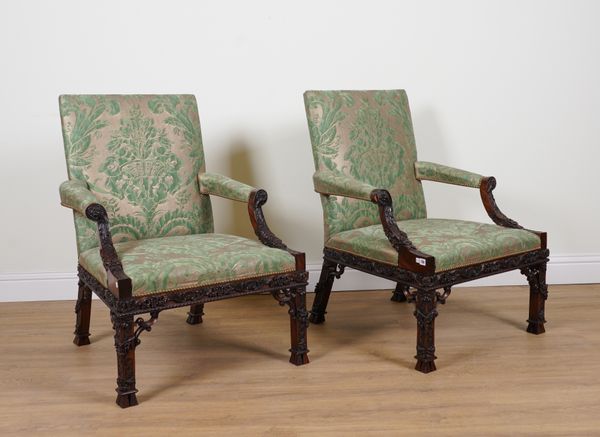 A PAIR OF GEORGE III STYLE, EXTENSIVELY CARVED MAHOGANY FRAMED GAINSBOROUGH OPEN ARMCHAIRS (2)