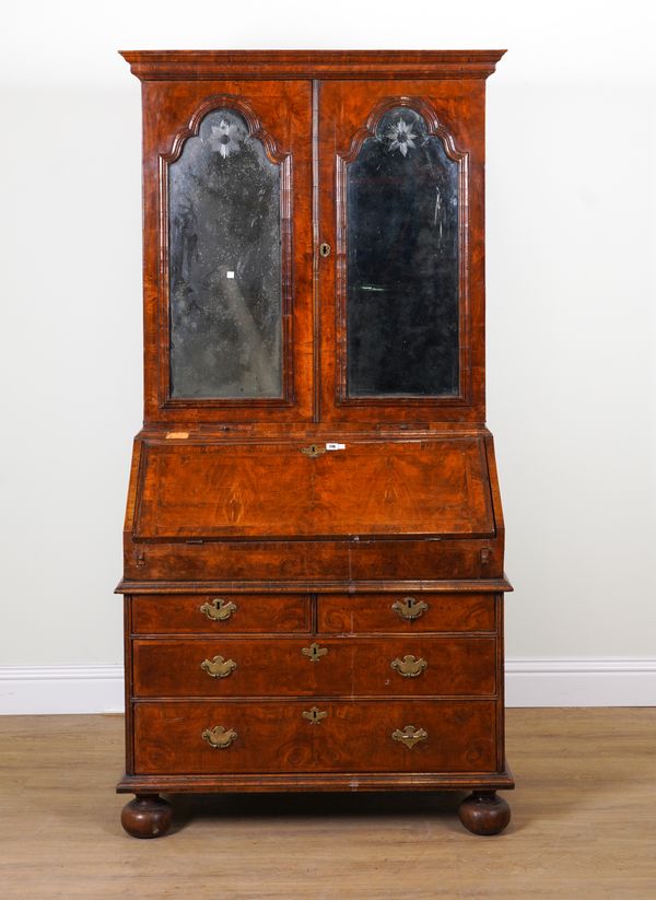 A GEORGE II FEATHER BANDED WALNUT BUREAU BOOKCASE