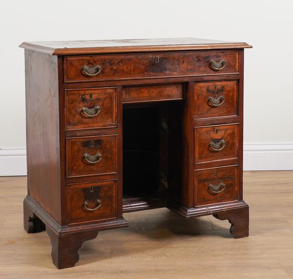 A GEORGE III WALNUT EIGHT DRAWER KNEEHOLE WRITING DESK