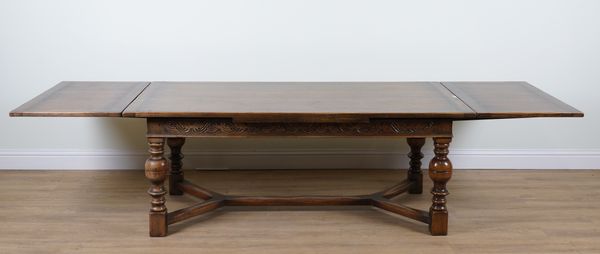 A 17TH CENTURY STYLE OAK DRAW LEAF EXTENDING DINING TABLE