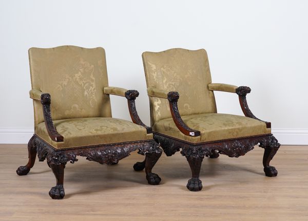 A PAIR OF GEORGE II STYLE CARVED MAHOGANY OPEN ARMCHAIRS (2)