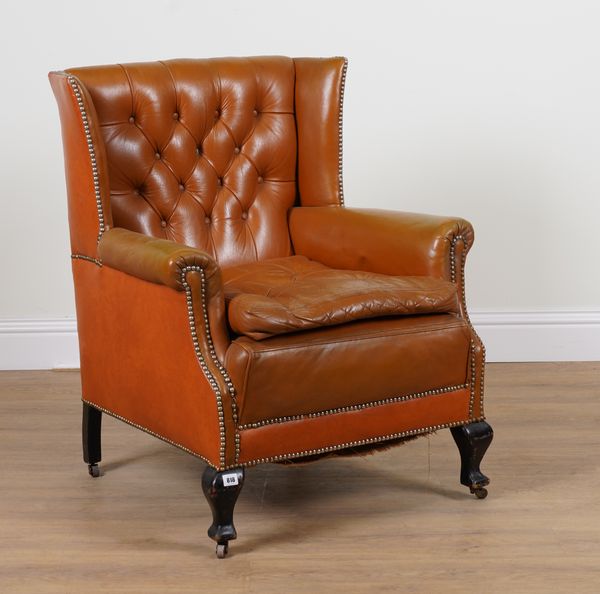 A TAN LEATHER UPHOLSTERED SQUARE WINGBACK ARMCHAIR