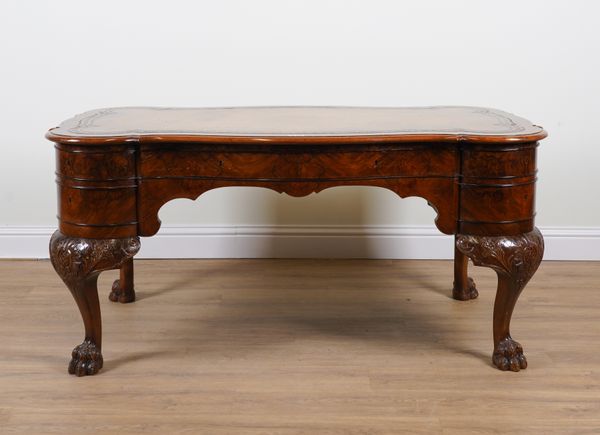 A GEORGE II STYLE FIGURED WALNUT CENTRE WRITING TABLE