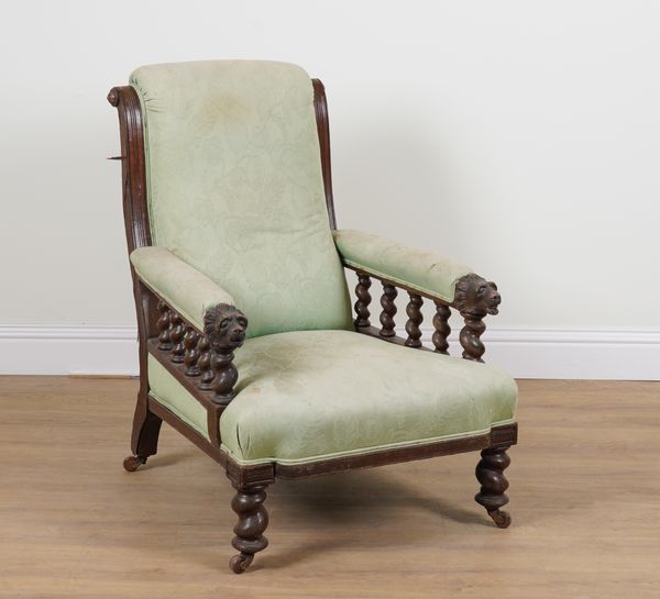 A VICTORIAN OAK FRAMED LOW ARMCHAIR