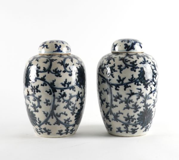 A PAIR OF CHINESE BLUE AND WHITE CRACKLE-GLAZED OVIFORM JARS AND COVERS (4)