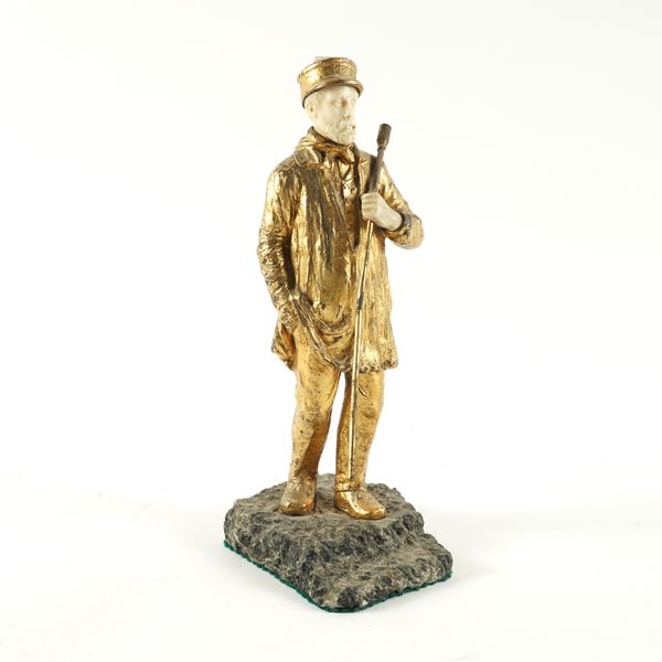 A CONTINENTAL GILT-BRONZE AND IVORY FIGURE OF A MAN