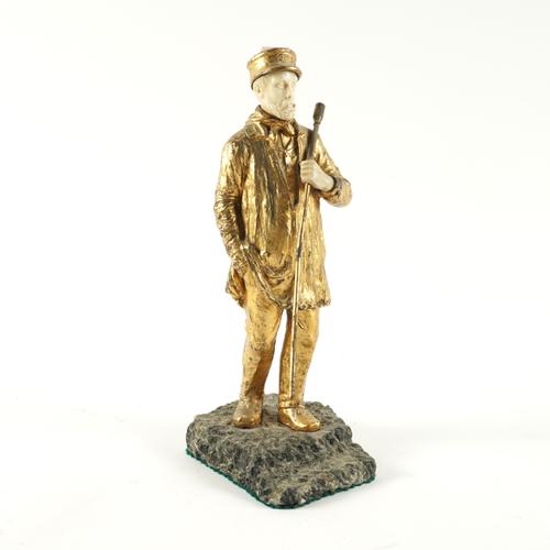 A CONTINENTAL GILT-BRONZE AND IVORY FIGURE OF A MAN