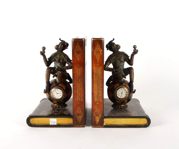 A PAIR OF LEATHER AND METAL MOUNTED HARLEQUIN MONKEY CLOCK BOOKENDS (2)