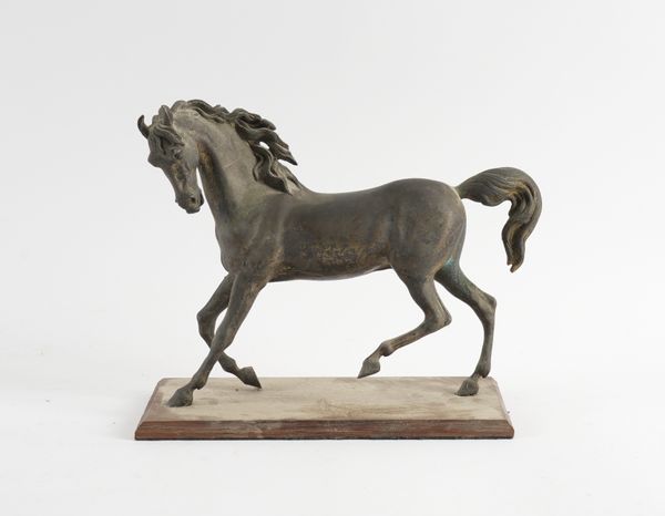 AN EQUESTRIAN GILT BRONZE ALLOY MODEL OF A STALLION