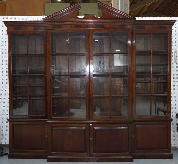 A LATE GEORGE III MAHOGANY BREAKFRONT BOOKCASE CABINET