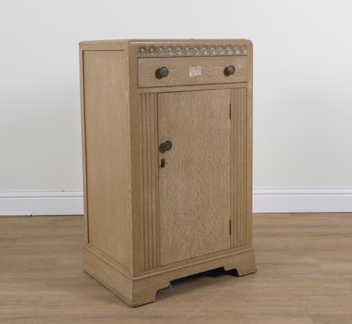 A MID 20TH CENTURY POLYCHROME PAINTED AND LIMED FLORAL CARVED OAK SIDE CABINET