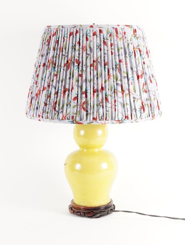 AN ACID YELLOW GLAZED CERAMIC LAMP