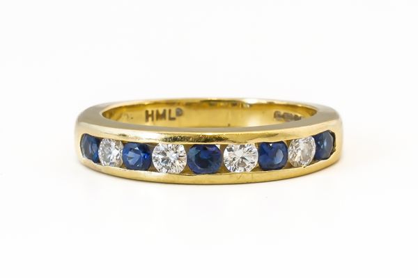 A SAPPHIRE AND DIAMOND HALF ETERNITY RING