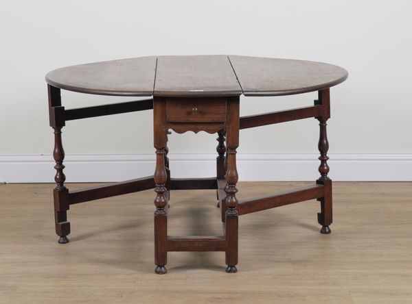 AN 18TH CENTURY WALNUT GATELEG DINING TABLE