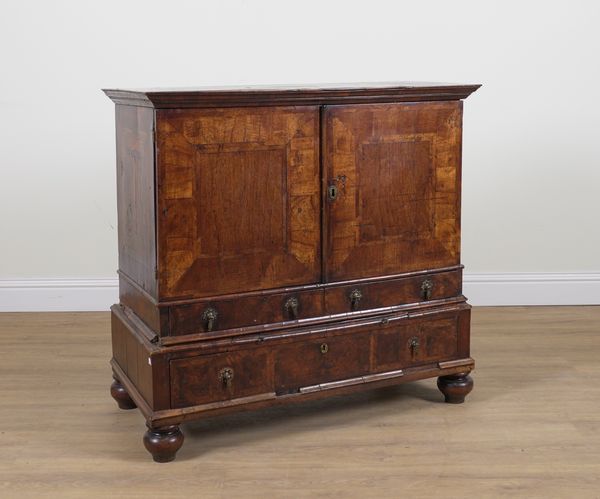 A GEORGE I AND LATER WALNUT CABINET ON STAND