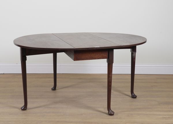 A GEORGE II MAHOGANY DROP FLAP OVAL DINING TABLE