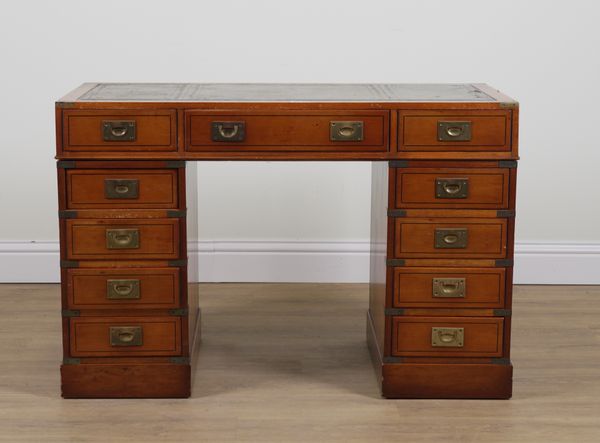 A CAMPAIGN STYLE BRASS BOUND YEW WOOD ELEVEN DRAWER PEDESTAL DESK