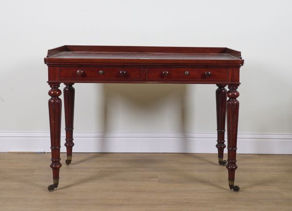 A EARLY 19TH CENTURY MAHOGANY GALLERIED TWO DRAWER WRITING TABLE