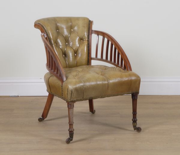 AN EDWARDIAN GREEN LEATHER BUTTON BACK UPHOLSTERED LOW TUB CHAIR