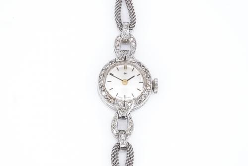A PLATINUM CASED  AND DIAMOND SET LADY'S CIRCULAR CASED DRESS WRISTWATCH