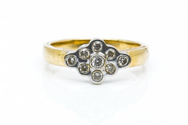 AN 18CT GOLD AND DIAMOND NINE STONE CLUSTER RING